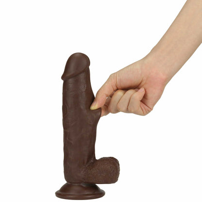 a person's hand to reference the size of the get lucky real skin suction cup dildo luck dark brown 7.5in