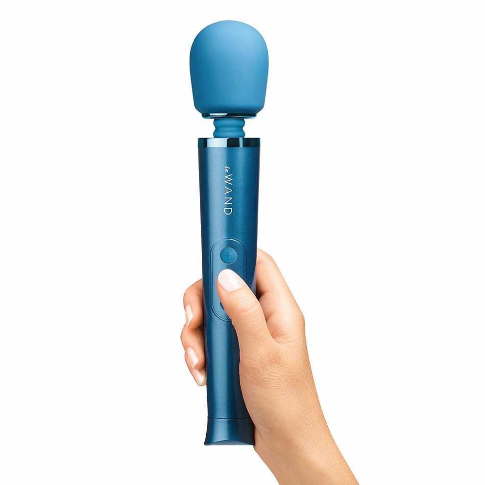 person holding the le wand petite rechargeable massager lw-007blu blue