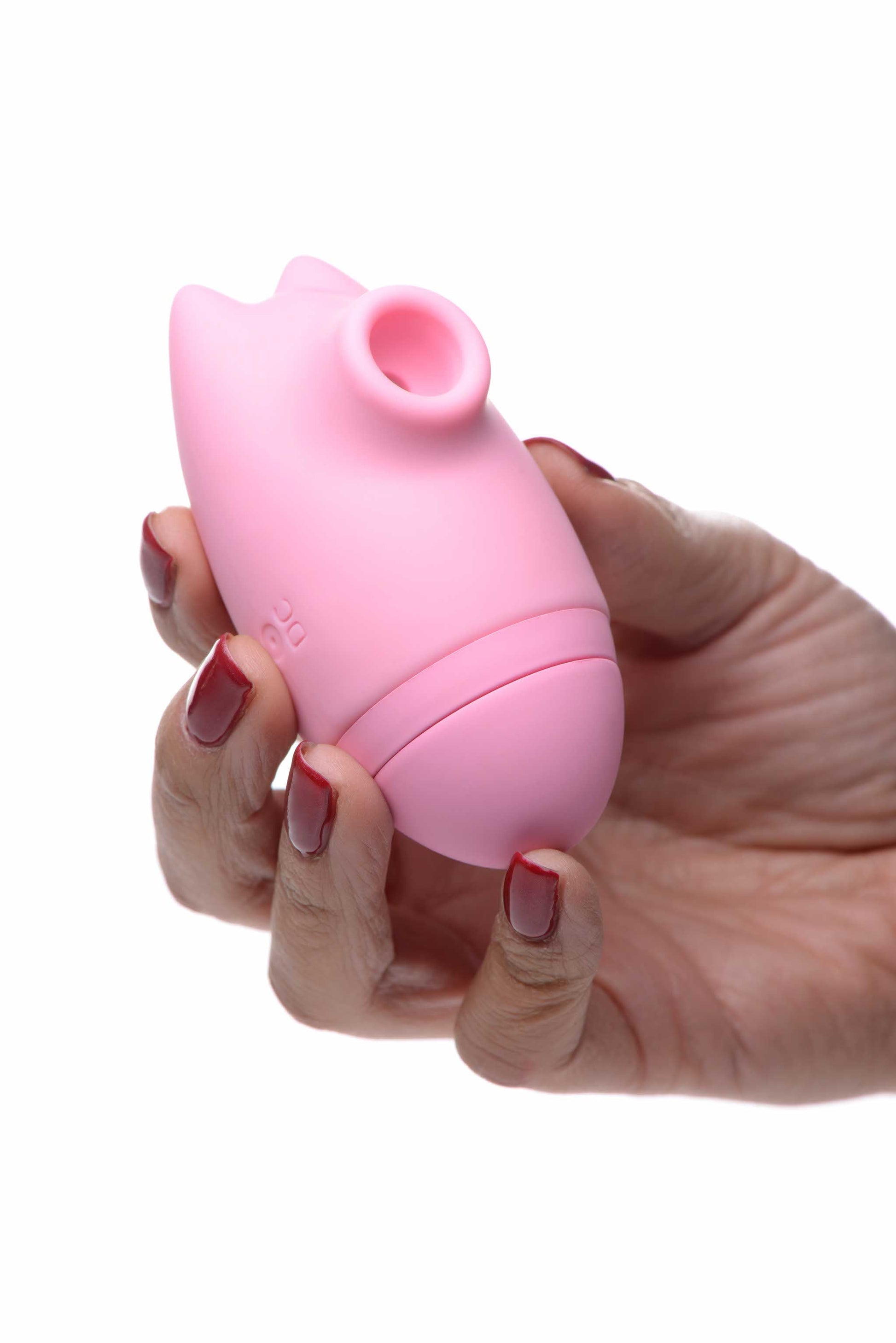 person holding the inmi shegasm kitty licker 5x silicone rechargeable clit stimulator pink xr-ag628