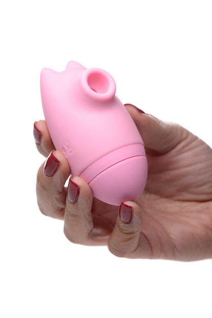 person holding the inmi shegasm kitty licker 5x silicone rechargeable clit stimulator pink xr-ag628