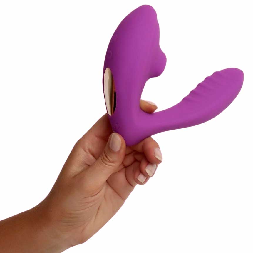 a person's hand to reference the size of the voodoo beso plus air pulse suction vibrator purple