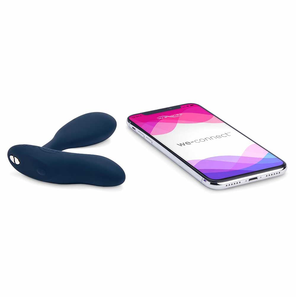 a smartphone laying next to the we-vibe vector vibrating prostate massager wvsnvcsg6 black
